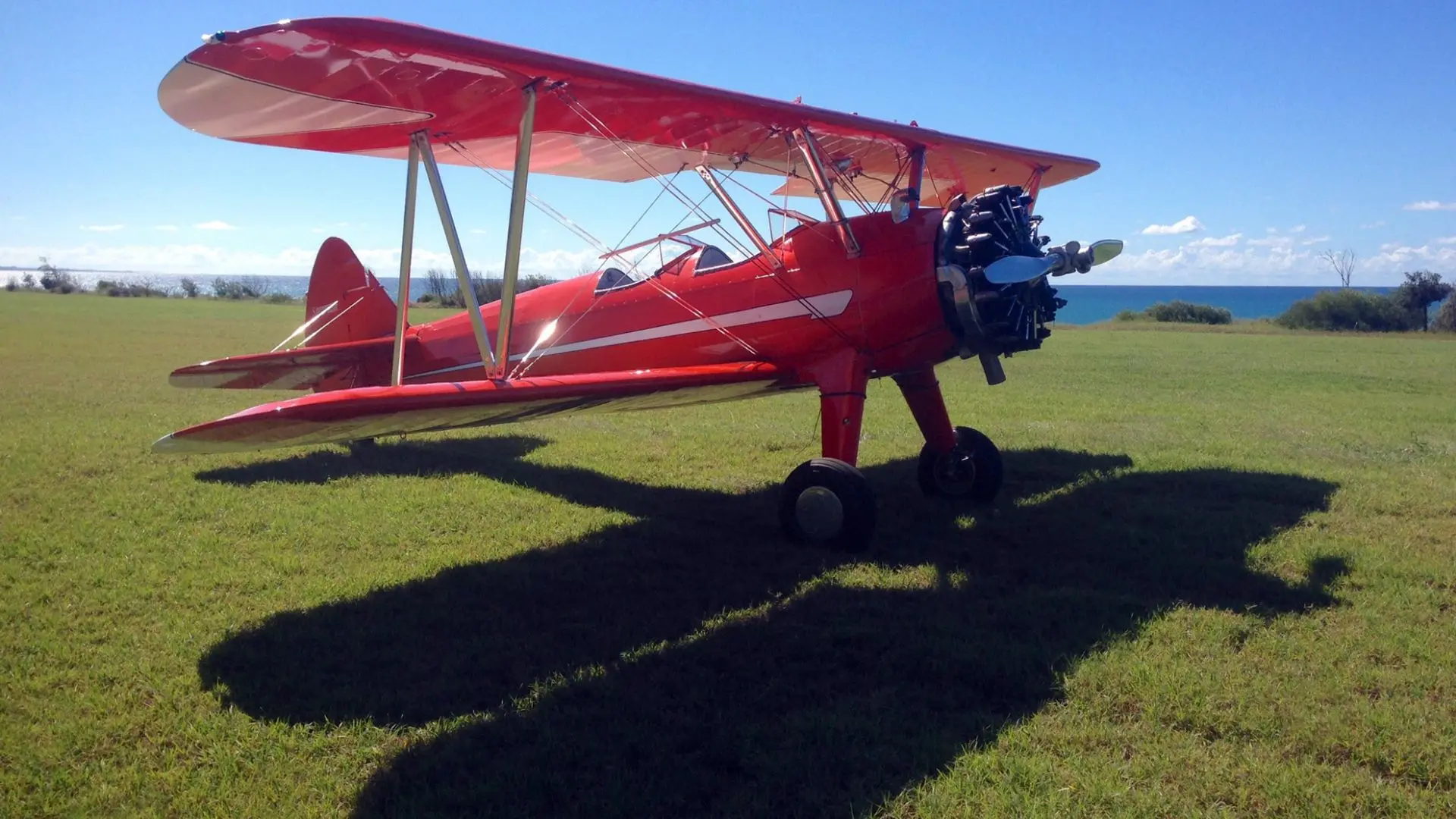 Red Stearman bi-wing plane